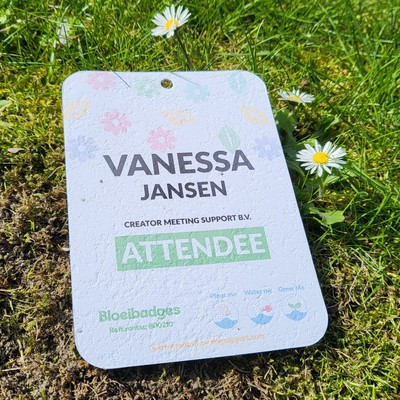 Bloeibadge in gras met bloem